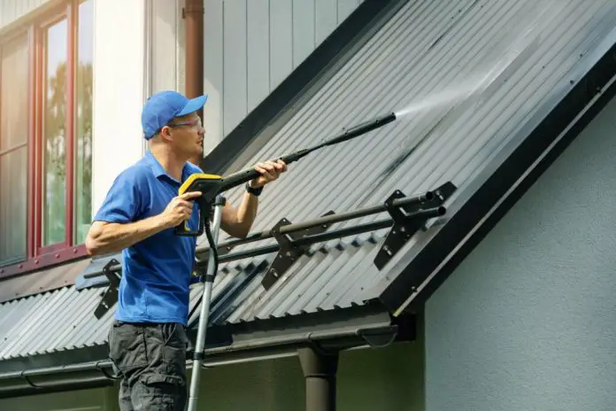 cleaning gutters with a pressure washer
